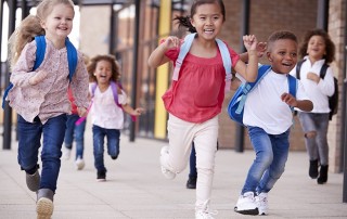Young elementary school kids leaving class on the last day of the year. These young people will need to manage jaw dysfunction their entire lives. Fortunately, they don’t have to do it alone. We can help manage the symptoms and complications of JIA.