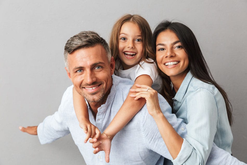 young family goofing around while taking a picture
