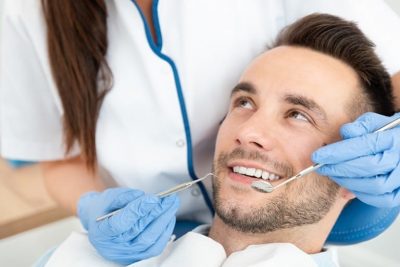 A man having a dental exam, preparing for orthodontic treatment. Whether you had braces as a teenager and you stopped wearing your retainer over the years and your teeth shifted back, or you never had orthodontics in your teens but you want a straighter smile, Dr. Firouzian can help.