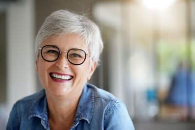 mature adult woman smiling with teeth, happy